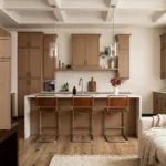 Modern kitchen rendering featuring light oak Slim Shaker cabinet doors. These doors show the distinct, linear, vertical grain of Rift Cut White Oak Veneer, highlighted by natural sunlight.