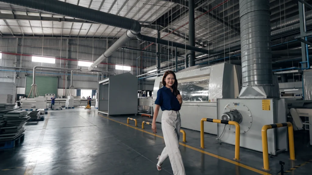 Quyen Do Thi, Quality Control Specialist and Business Development Manager at theShaper, inspecting RTA cabinet assembly line at Blue Valley Cabinetry.