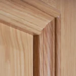 Close-up profile detail of the 5-piece Double Raised Panel White Oak door illustrating the cope-and-stick joinery and compound molding profile.