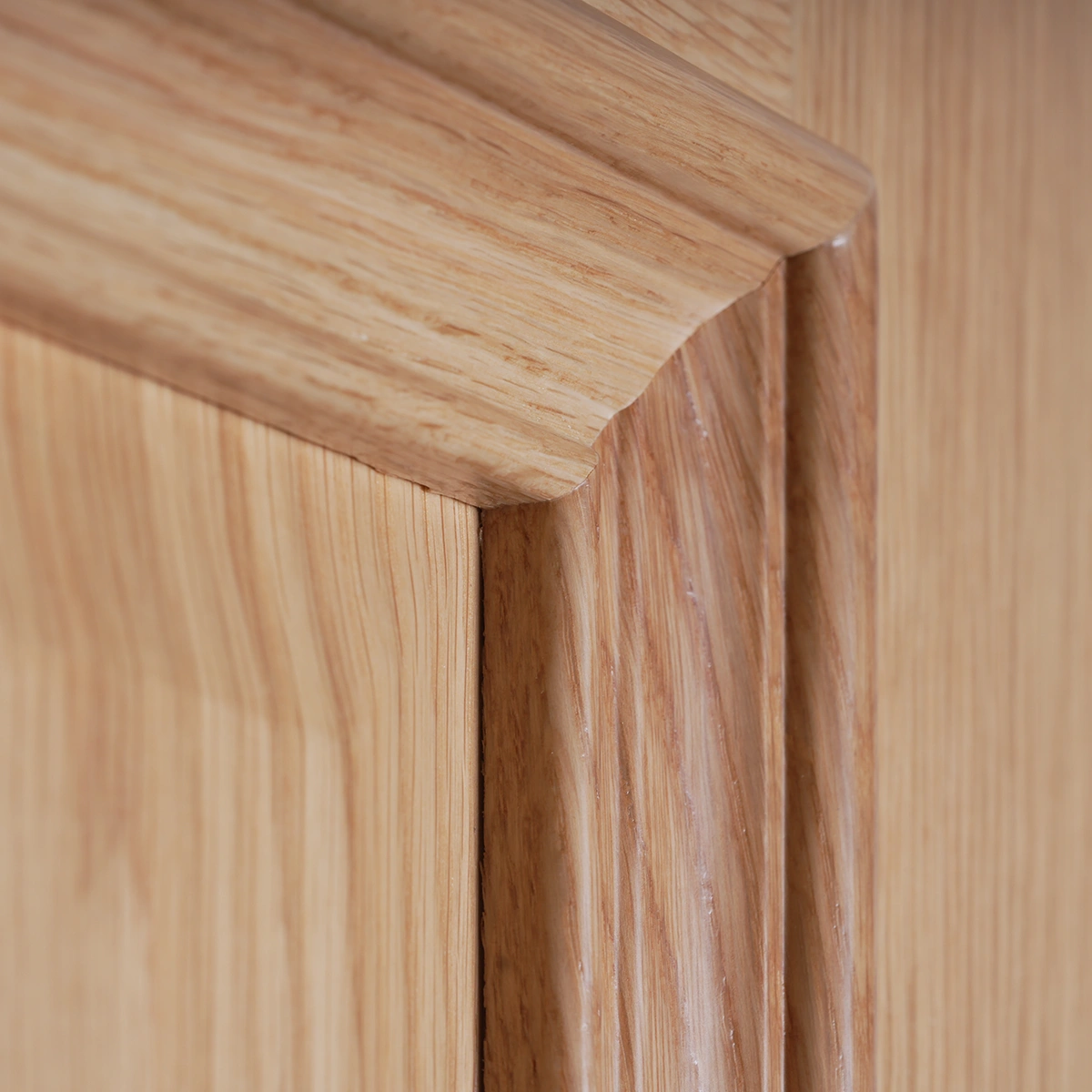 Close-up profile detail of the 5-piece Double Raised Panel White Oak door illustrating the cope-and-stick joinery and compound molding profile.