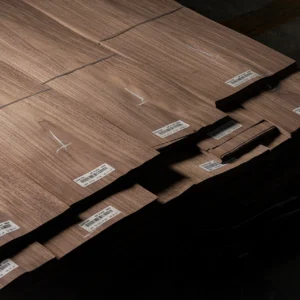 A bundled stack of Crown Cut American Black Walnut veneer sheets marked with quality assurance and specification labels by theShaper.
