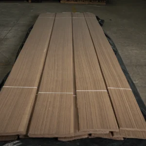 Industrial pallets of premium unspliced American Black Walnut Rift Cut veneer by theShaper, featuring straight linear wood grain.