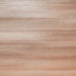 Macro texture photograph highlighting the porous, high-density wood fibers and uniform surface of Red Grandis quarter cut veneer.