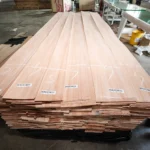 Bundled pallets of premium Red Grandis quarter cut wood veneer sheets, securely wrapped and prepared for international shipping at theShaper facility.