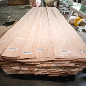Bundled pallets of premium Red Grandis quarter cut wood veneer sheets, securely wrapped and prepared for international shipping at theShaper facility.