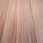 High-angle close-up shot showcasing the straight, parallel grain lines and smooth texture of Red Grandis quarter cut veneer sheets.