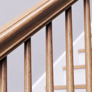 Close-up shot of the classical staircase detail featuring the Heritage Contoured solid oak handrail with decorative side molding.