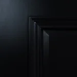 Upper rail and glass frame corner joint on Midnight Iron door