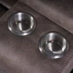 Close-up detail of built-in stainless steel drink holders on Bradford loveseat console.