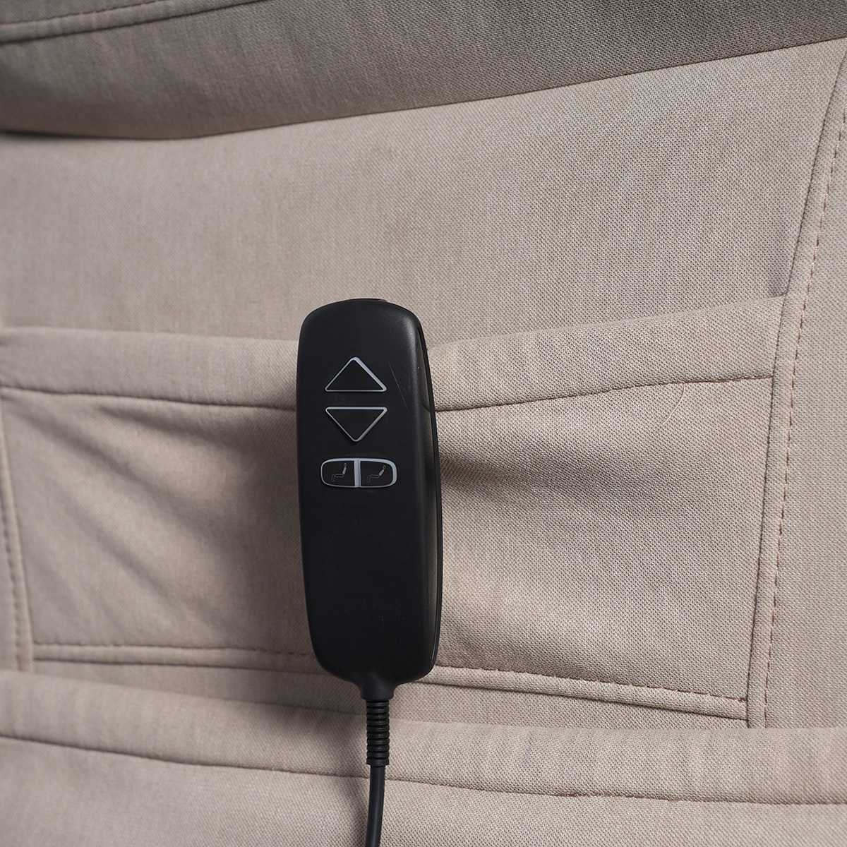 Close-up of intuitive handheld remote control wand with large lift and recline buttons.