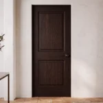 Classic 2-Panel Raised Panel pine interior door stained in deep dark Espresso in a modern luxury corridor