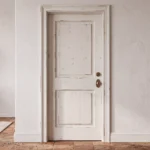 Classic 2-Panel Raised Panel pine interior door finished in Distressed Antique White in a modern farmhouse setting