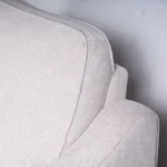 Close-up of plush pillow headrest and ergonomic back cushion stitching.