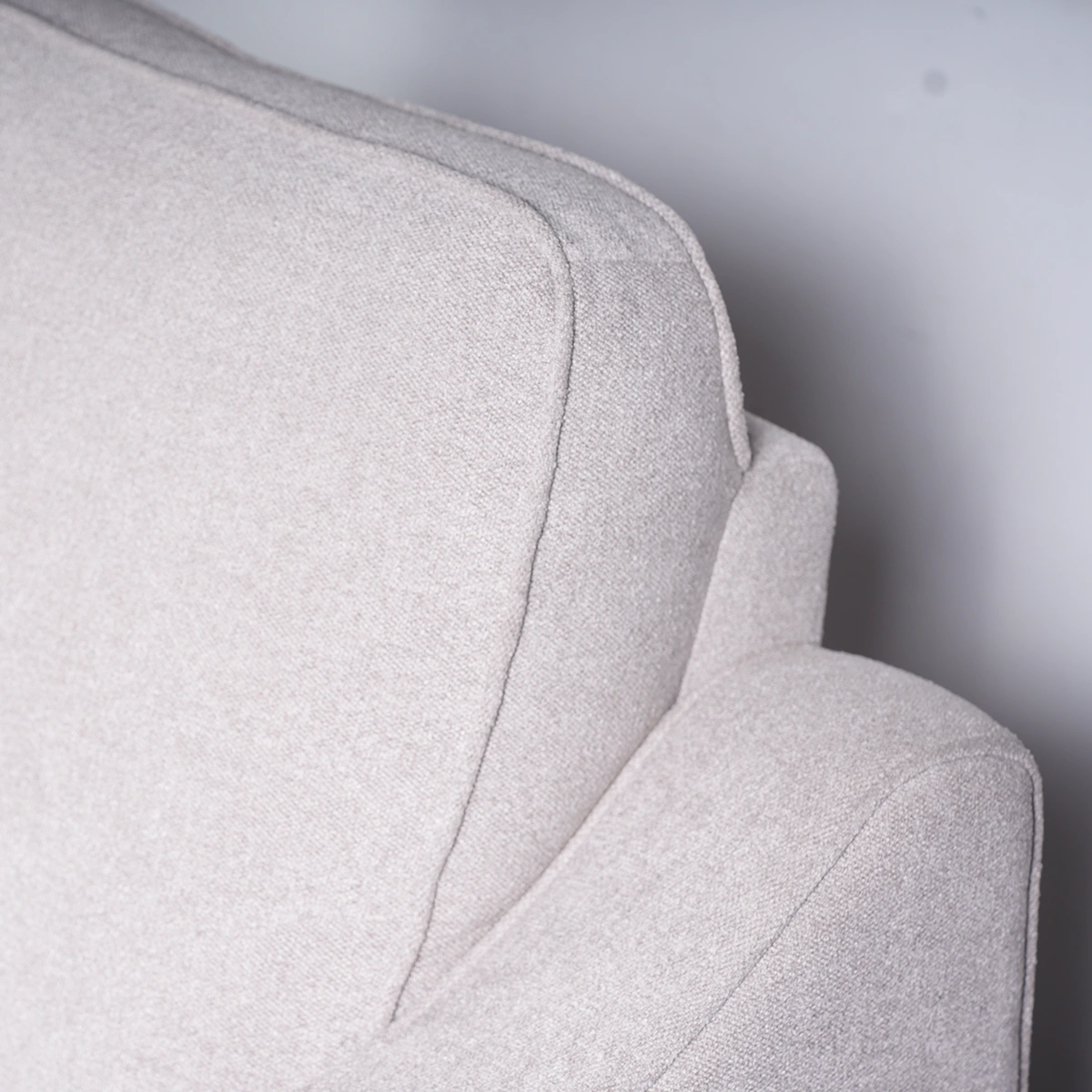 Close-up of plush pillow headrest and ergonomic back cushion stitching.