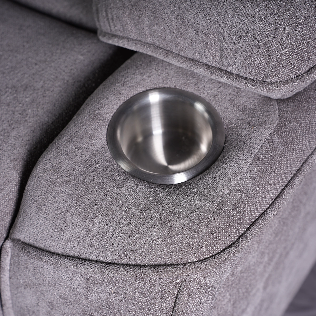 Close-up of dual recessed stainless steel cup holders built into armrests.