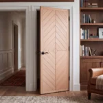 Geometric Diamond-Matched Oak interior slab door installed in a luxury modern primary suite