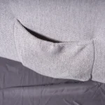 Close-up of deep side storage pocket on Kyoto recliner holding reading material and remote.