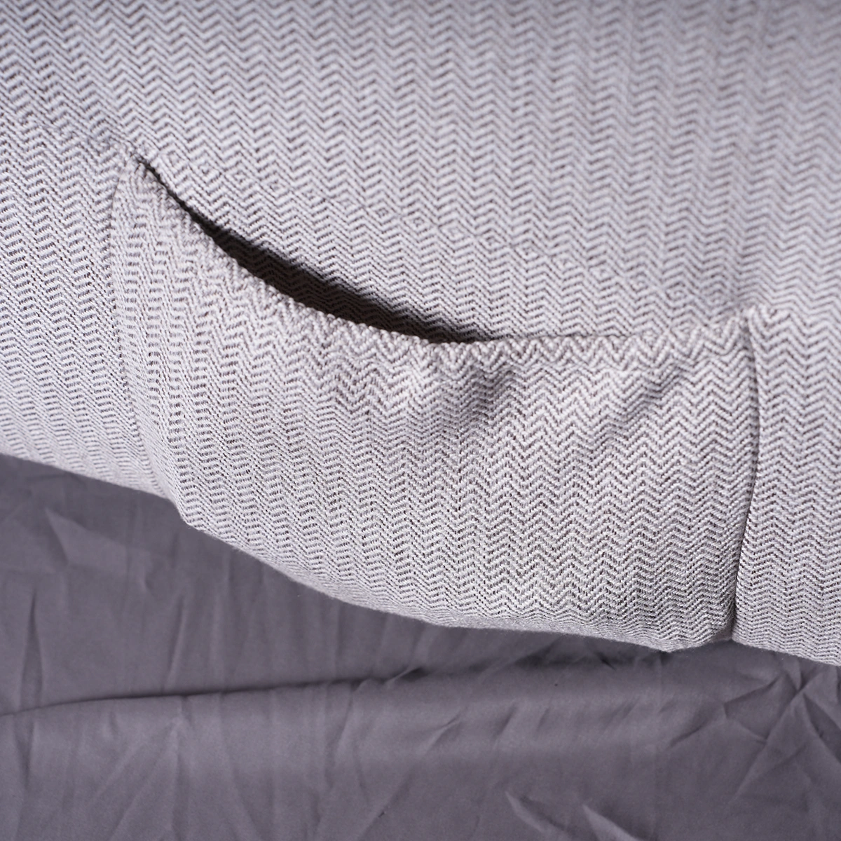Close-up of deep side storage pocket on Kyoto recliner holding reading material and remote.