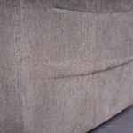 Close-up detail of convenient side storage pocket on Mason power motion recliner holding wired remote and magazine.