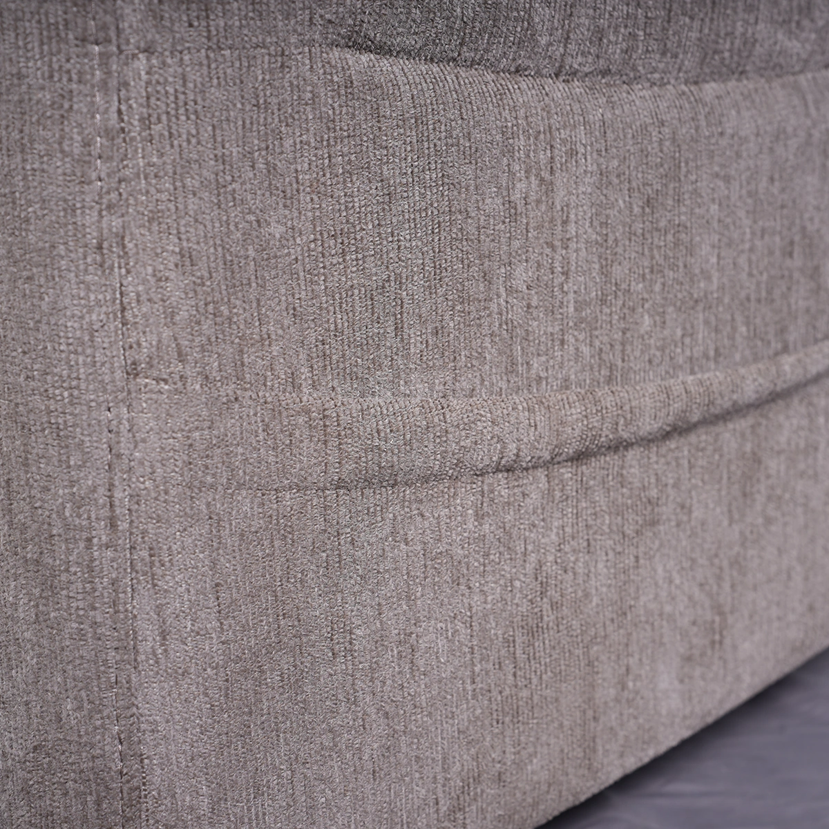 Close-up detail of convenient side storage pocket on Mason power motion recliner holding wired remote and magazine.