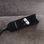 Close-up of user-friendly wired handheld remote controller with large intuitive buttons.