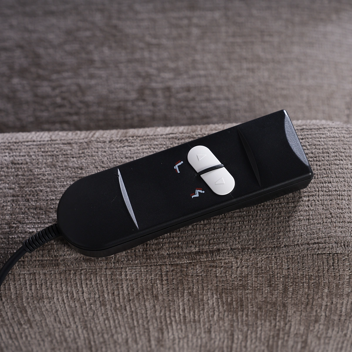 Close-up of user-friendly wired handheld remote controller with large intuitive buttons.