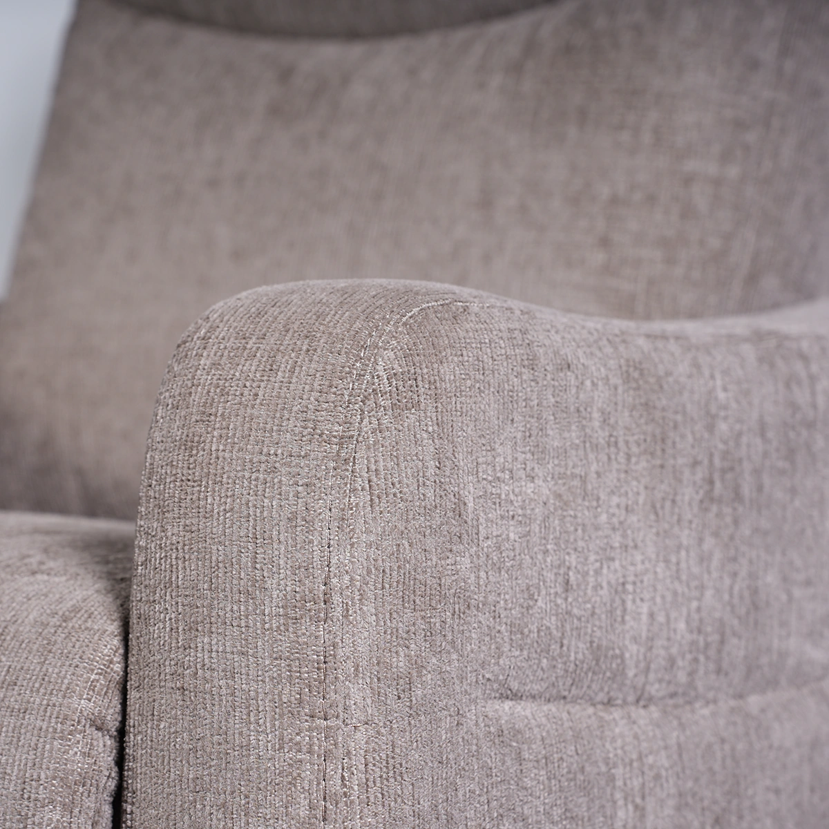 Close-up of padded track armrest showing crisp stitching and durable fabric weave.