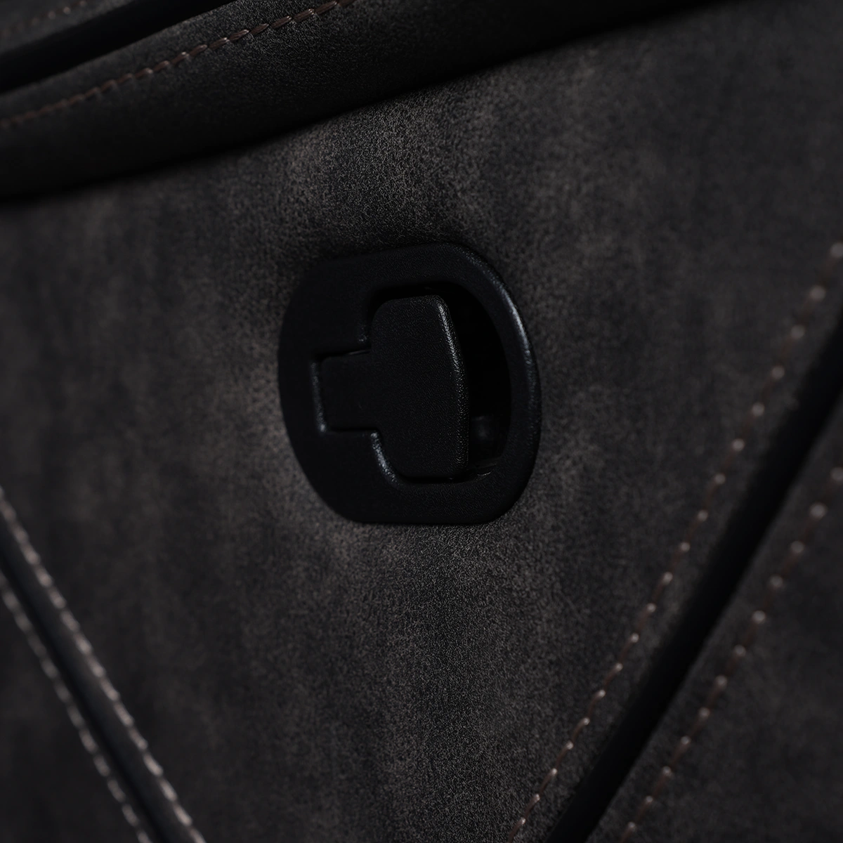 Close-up of exterior recessed manual pull-tab recline release mechanism on side panel.