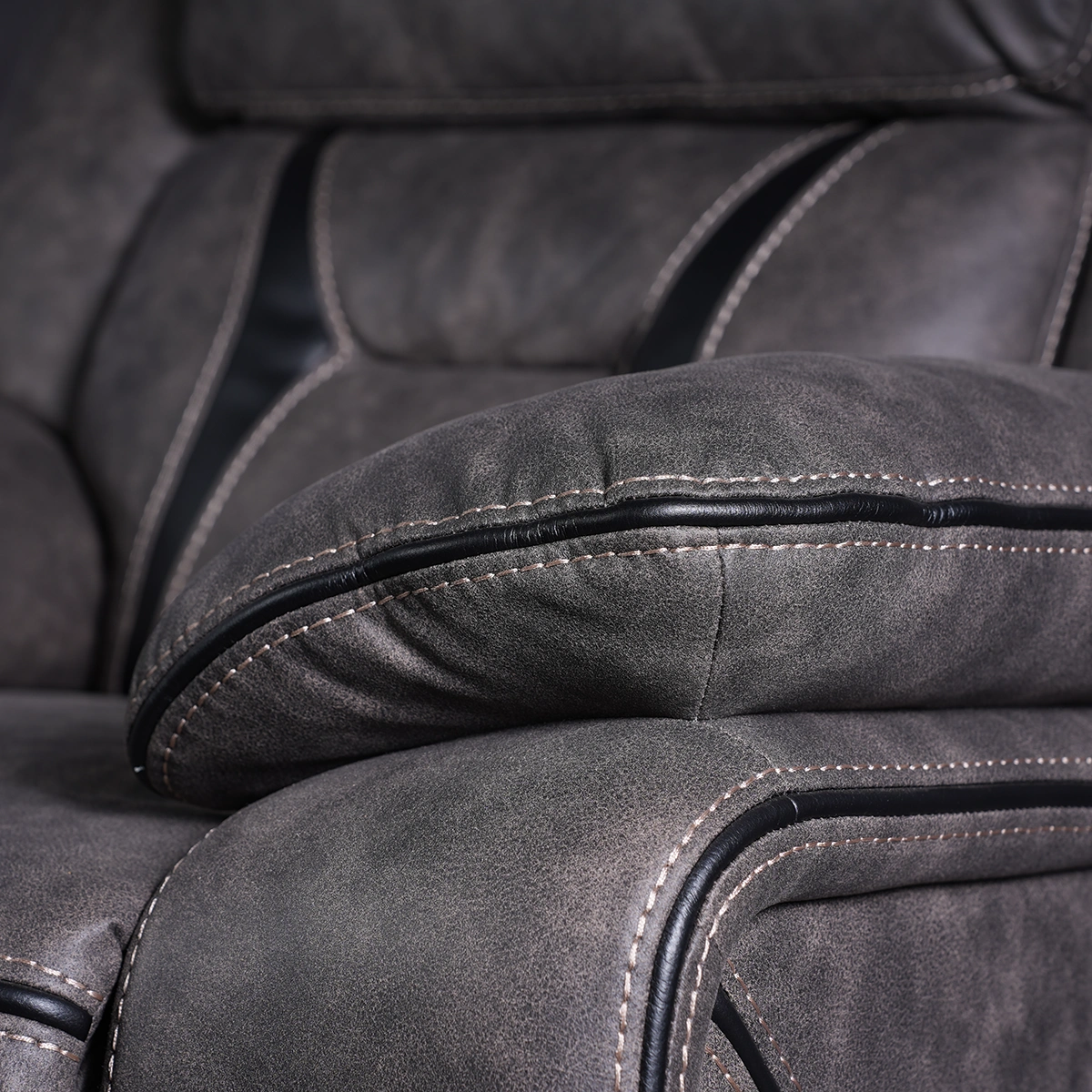 Close-up detail of sporty ergonomic plush pillow-top armrest with durable vintage faux leather stitching.