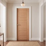 Modern Horizontal Slat White Oak interior door installed in a luxury contemporary bedroom corridor