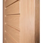 Macro close-up of horizontal CNC reveal groove and open-grain white oak texture