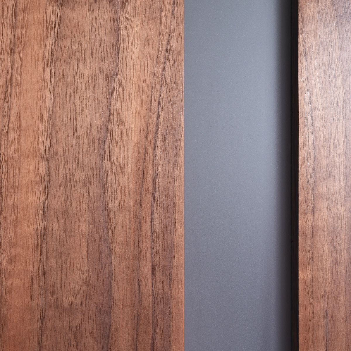 Detailed close-up of the tempered safety glass reveal against deep smoked walnut timber