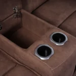 Close-up of open flip-top storage compartment and dual stainless steel cup holders on loveseat console.
