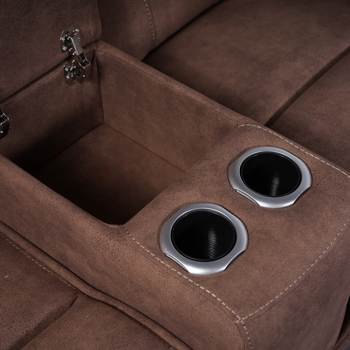 Close-up of open flip-top storage compartment and dual stainless steel cup holders on loveseat console.