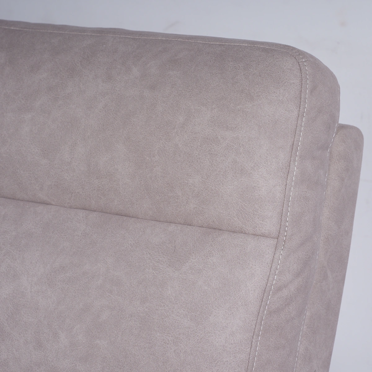 Close-up of plush backrest cushion tailored in taupe beige suede-feel eco-leather.