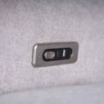 Close-up of brushed metal power recline toggle buttons with integrated USB-A and USB Type-C ports.