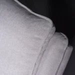 Close-up of ergonomic backrest showing breathable, anti-pilling heavyweight woven fabric texture.