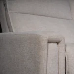 Close-up of generously padded modern track armrest showing tailored edge stitching.