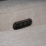 Close-up of metallic power recline switch panel with integrated USB charging ports and power outlets.