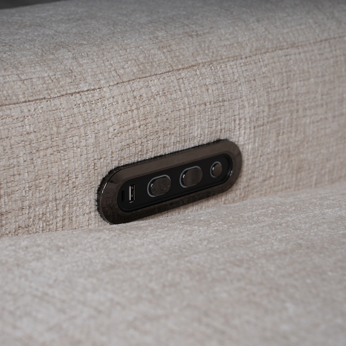 Close-up of metallic power recline switch panel with integrated USB charging ports and power outlets.
