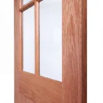 Macro close-up of 4-lite glazed muntin bars meeting vertical planked grooves on Nordic Wheat Oak door